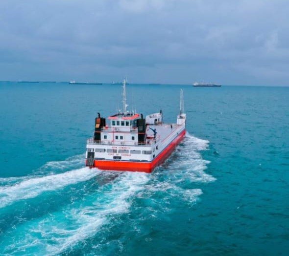 A ferry underway on open water, seen from above