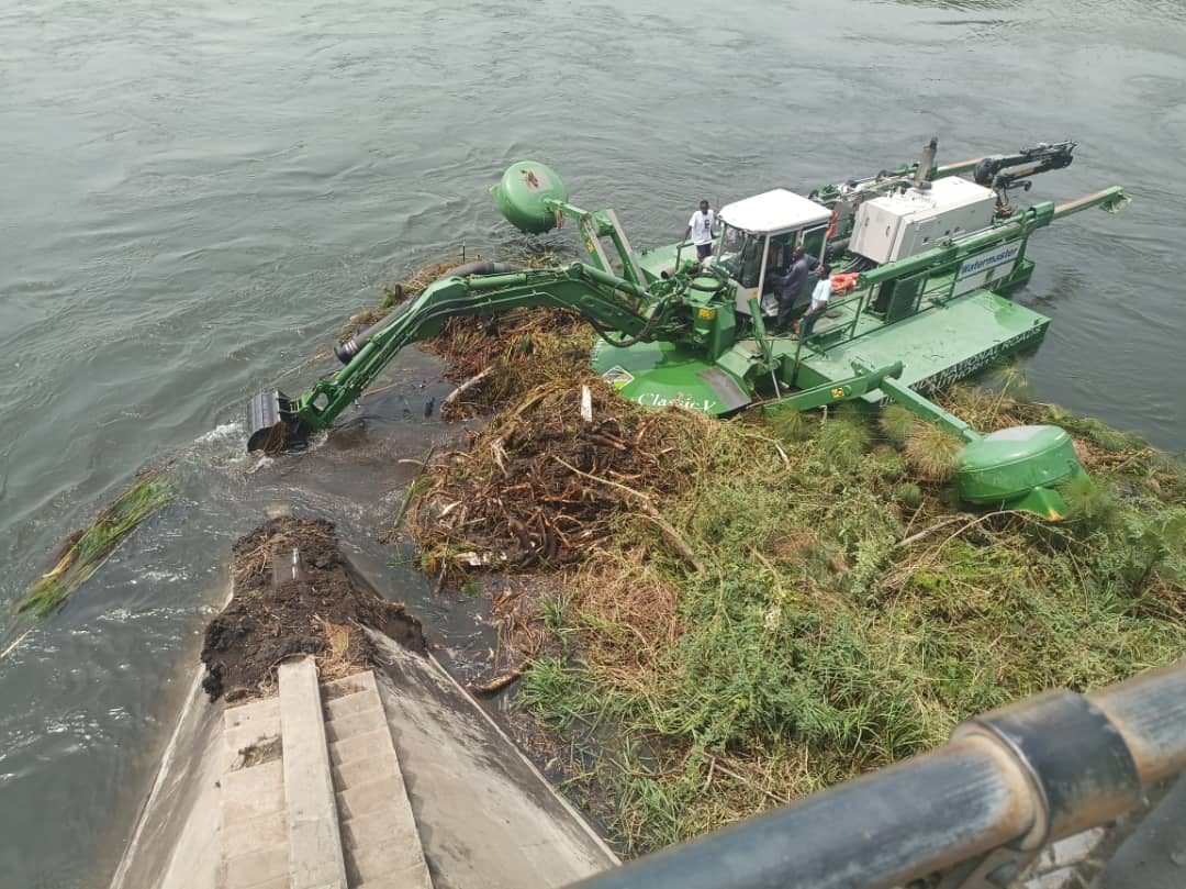 Watermaster amphibious dredger clearing vegetation from a waterway